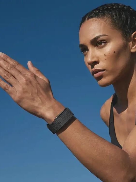Athletic woman wearing the Human Band outdoors — building metabolic momentum